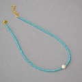 Detailed view of turquoise beaded necklace with baroque pearl and golden lobster clasp - Blue Turquoise