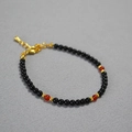 Detail of beaded necklace with black and red agate beads and gold lobster clasp closure - Black Round Beads + Red Agate Bracelet
