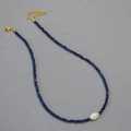 Detail of beaded necklace with black spinel, turquoise, and a baroque pearl focal bead - Lapis Lazuli