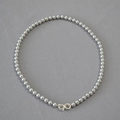 Detail of dark grey pearl necklace featuring a silver infinity shaped lobster clasp - Silver Gray Necklace 6mm