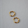 Close-up of gold-plated brass hoop earrings featuring rich brown enamel inlay segments - Brown