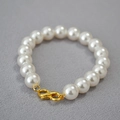 Close-up of high-luster round white pearls with a golden S-shaped metal clasp - Creamy White Bracelet 10mm