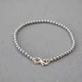 Detail of the infinity symbol clasp on a minimalist silver beaded bracelet - Silver Gray Bracelet 3mm