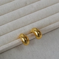 Polished chunky gold teardrop earrings made of gold-plated brass on a linen jewelry box - Gold