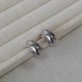 Minimalist silver teardrop stud earrings with a polished mirror finish in a display box - White Gold