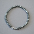 Detail view of high-luster dark grey imitation Tahitian pearl necklace with silver magnetic clasp - 10mm Necklace / Tahiti Gray