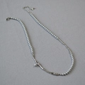 Detail of grey pearl necklace featuring irregular silver metal branch piece and lobster clasp - Silver