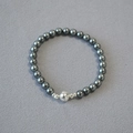 Macro shot of 8mm dark grey pearl beads with silver spherical magnetic clasp detail - 6mm Bracelet / Tahiti Gray