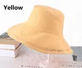 Close-up of bright yellow cotton bucket hat with 'Seek your beauty' embroidery detail - One Size 58cm / Yellow
