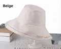 Detail of beige cotton bucket hat featuring Seek Your Beauty embroidery and stitching - One Size 58cm / Beige