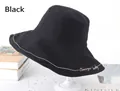 Detail of black cotton bucket hat with beige embroidery and wide brim on a stand - One Size 58cm / Black
