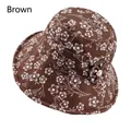 Detail of a brown floral bucket hat with decorative fabric flower and pearl accent - Adjustable 56-58cm / Brown (Plum Blossom)