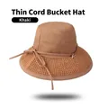 Detail of khaki bucket hat featuring woven straw brim and slim decorative rope with accents - One Size 58cm / Khaki