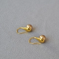 Close-up of champagne pearl drop earrings with golden water-drop metal accents - 8mm Hooks