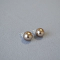 Champagne pearl stud earrings with 925 silver needles on textured gray fabric - 12mm Stud Earrings