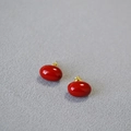 Detail of red enamel oval stud earrings with elegant gold metal pins and glossy finish - Large Red Beans