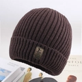 Close-up of dark brown ribbed knit beanie with leather patch on vintage books - One Size / Deer Plush Sport Logo Coffee