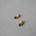 Minimalist gold-plated stud earrings with deep blue lapis lazuli on gray fabric - Lapis Lazuli