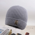 Close-up of gray knit beanie with ribbed texture and brown leather patch logo - One Size / Deer Plush Sport Logo Light Gray