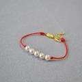 Handmade red cord bracelet with five round white pearls and golden lobster clasp - Faux Pearl Style