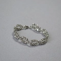 Detailed view of dual-row woven laser-cut silver beads bracelet with sparkling facets - White Gold