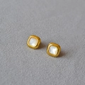 Macro shot of square gold earrings with iridescent mother of pearl inlay on gray fabric - Square Mother-of-pearl Stud Earrings