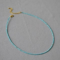 Detail of turquoise beaded necklace with golden lobster clasp and extension chain - Turquoise Square