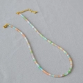 Macro view of multi-colored translucent square crystal beads with gold lobster clasp - Colorful Cat's Eye