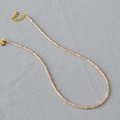 Detail of champagne crystal beaded necklace with golden lobster clasp and adjustable chain - Champagne