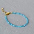 Macro shot of blue faceted crystal beads with a gold-plated adjustable lobster clasp - Aqua Blue Zirconia