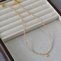 Elegant beaded star necklace with champagne zircon pendant on a jewelry display tray - Champagne Zirconia