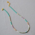 Colorful beaded necklace with turquoise, lavender, and pink beads with gold spacers - Necklace