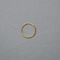 Close-up of minimalist thin gold ring band on textured dark grey stone surface - Gold Plain Band / US 5