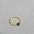 Detail of handmade beaded ring featuring a blue gemstone and yellow crystal beads - Lapis Lazuli