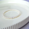 Elegant white pearl bracelet featuring a square-cut sparkling zircon on a ceramic tray - Bracelet