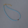 Detail of beaded necklace with blue faceted gems and amber center stone pendant - Sky Blue Chain with Red-brown Bead / Red Agate Necklace