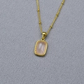 Macro detail of gold-plated necklace with a rectangular pink stone pendant - Rose Quartz