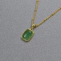 Detail of a vintage geometric green stone pendant on a gold beaded necklace chain - Green Strawberry Quartz
