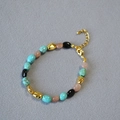 Dettaglio della collana di perle turchesi con accenti dorati e chiusura regolabile - Bracciale