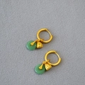 Detailed shot of gold earrings with green jade rings and delicate lotus seed pod charms - Green Safety Buckle & Lotus