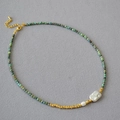 Detail of turquoise beaded necklace featuring a baroque pearl and adjustable lobster clasp - Turquoise Necklace