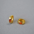 Minimalistische Goldene Messing Creolen mit ovalem orangem Zirkon auf grauem Grund - Orange
