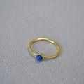 Minimalist gold plated brass ring with lapis lazuli stone set on grey background - Lapis Lazuli