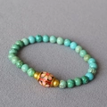 Macro detail of turquoise beaded bracelet with floral cloisonne bead and brass spacers - Pink Petal Cloisonne Barrel Bead Style(1)