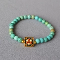 Macro detail of turquoise beaded bracelet with floral enamel cloisonné square charm - Colorful Traditional Floral Square Ornament Style (8)