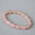 Detail of pink natural stone beads with smooth irregular shapes on a beaded bracelet - Pink