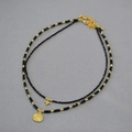 Double-layered beaded necklace with black spinel beads and celestial gold pendants - Layered Style