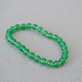 Macro di perle di agata verde con accenti dorati su uno sfondo con trama fine - Verde