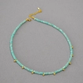 Amazonite beaded necklace with faceted blue stones and golden metal ball pendants - Necklace