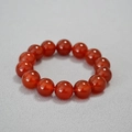 Macro shot of 14mm polished red agate beads showing smooth texture and high gloss finish - 14mm Red Agate